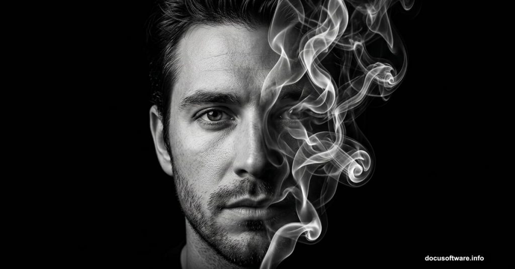 Half face dissolving into white smoke wisps against black background